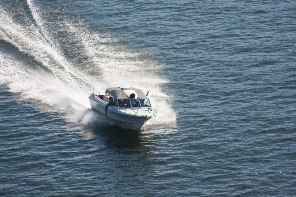people riding in a speedboat