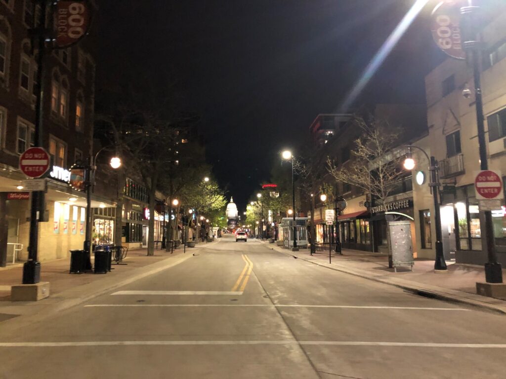 Picture of a Madison Police car driving down State Street in Madison at night